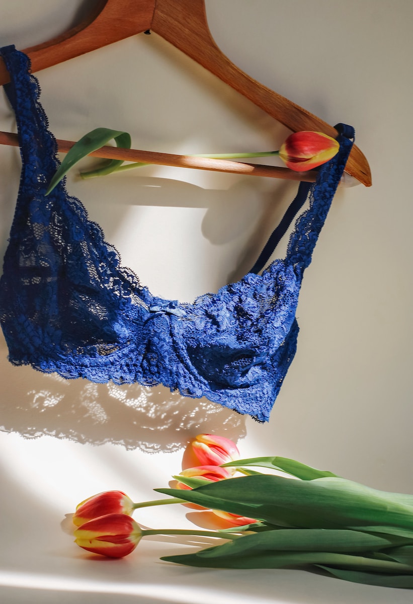 blue lace brassiere on white table