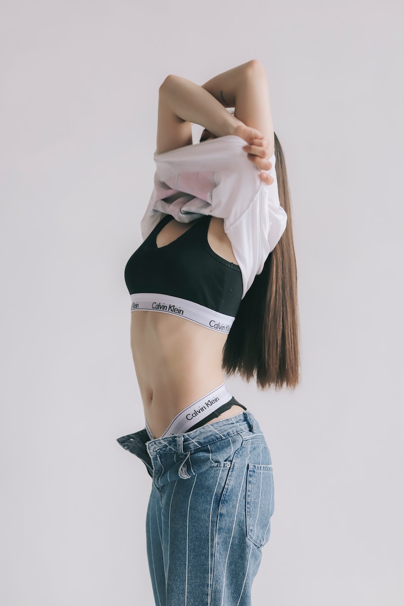 woman in black and white crop top and blue denim shorts